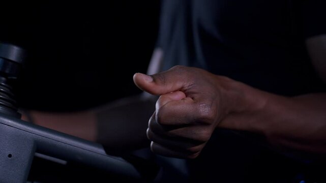 A close-up shot of a hand snapping fingers in slow motion with dramatic lighting and a dark background