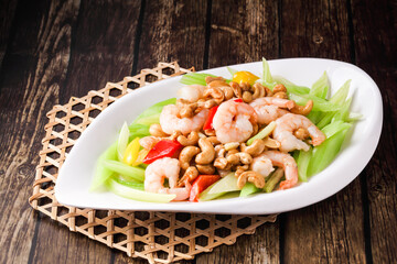 Shrimp with Celery and Cashew Nuts served in dish isolated on wooden background side view of hong kong food