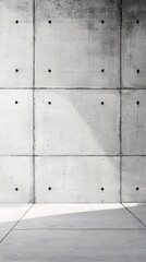 Fototapeta premium A minimalist concrete wall with a textured surface and subtle shadows, showcasing modern architectural design.