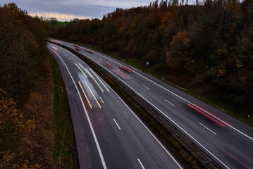 Fototapeta premium Night highway. You can see the streaks of light from the car headlights.