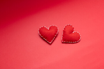 love and relationship abstraction, handmade wool red hearts on red background, dating and valentine's day concept
