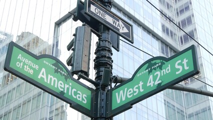 New York City crossroad, 42 street intersection road sign. 6 Sixth ave, Americas avenue corner, Midtown business district, NYC, Bryant park. Highrise skyscraper architecture, one way text roadsign.