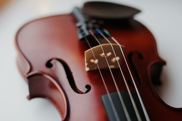 Fototapeta premium Close up of a violin on the white wooden table