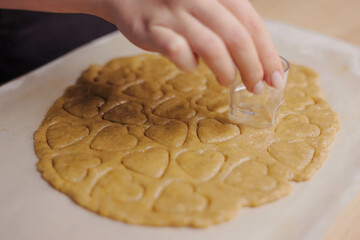 Woman preparing ginger cookies, Christmas and New Year traditional cookies.