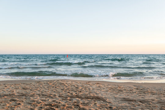 Red flag warning at the sea with high tide waves as signal for danger and hazard rip current activity in Thailand.