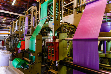A roll of plastic film is being manufactured