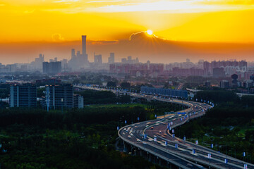 Road towards the sun: skyline of Beijing CBD area at sunset