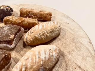 Traditional Arabic Sweets Selection on Wooden Table: A Colorful and Flavorful Feast.