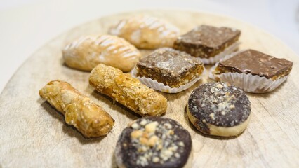 Traditional Arabic Sweets Selection on Wooden Table: A Colorful and Flavorful Feast.