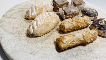 Traditional Arabic Sweets Selection on Wooden Table: A Colorful and Flavorful Feast.