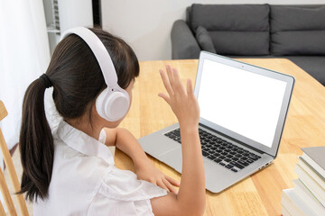 Chinese little girl attending online classes at home