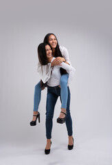 Joyful young adults enjoying piggyback ride