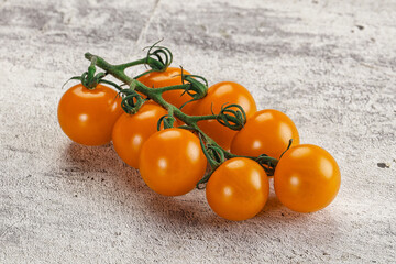 Yellow sweet tomato on the branch