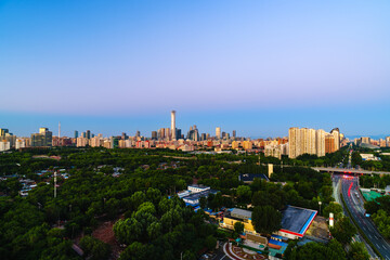 Naklejka premium Skyline of Beijing CBD at sunrise with golden sunlight on skyscrapers