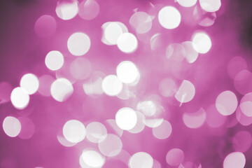 Purple, magenta, indigo bokeh background with soft, circular light spots in varying sizes. The...