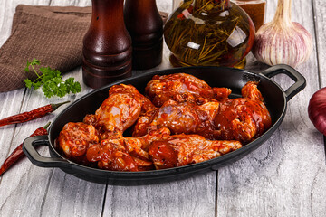 Raw marinated buffalo chicken wings