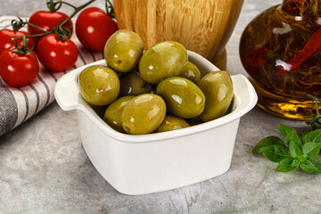 Big green marinated olives in the bowl