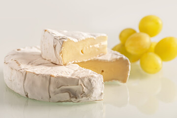 fresh delicious brie cheese and grapes close up shallow depth of field