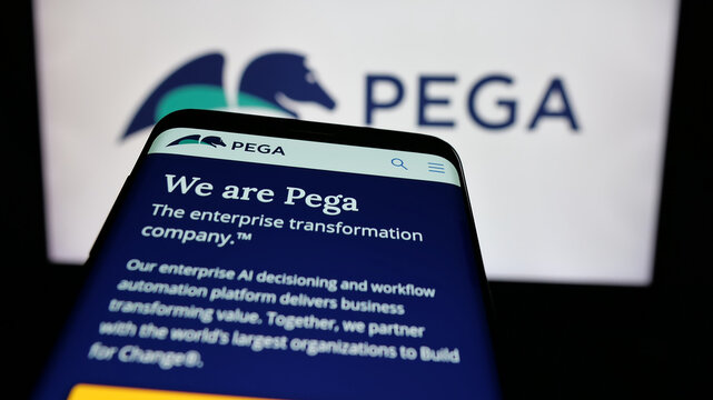 Stuttgart, Germany - 12-11-2024: Mobile phone with website of US software company Pegasystems Inc. (Pega) on screen in front of business logo. Focus on top-left of phone display.