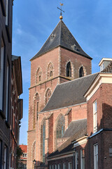 Brick tower of Onze Lieve Vrouwenkerk church in Kampen , The Netherlands, against blue sky