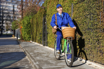 Obraz premium Postman with parcels in bicycle basket outdoors
