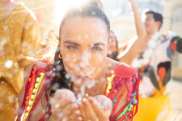 Confetti blow in the street of happy Carnival party. Brazil traditional festival abstract blurred...