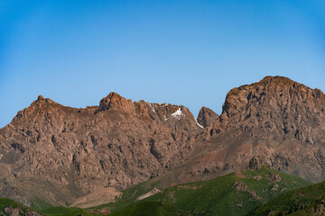 Under the blue sky and white clouds, the Qilian Mountains are covered in snow.