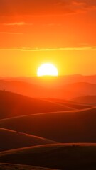Obraz premium Radiant Sunset Over Rolling Hills - Vertical Phone Wallpaper Background