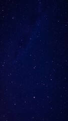 Obraz premium Dreamy Starry Night Sky with Shooting Stars - Vertical Phone Wallpaper Background