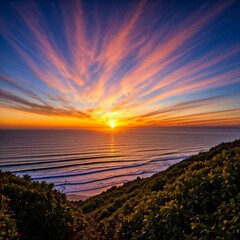 Naklejka premium The vivid colors of a sunrise over the ocean, with sunlight streaming through coastal mist. 