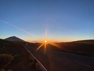 An orange sun at the horizon, illuminating the last moments of the day