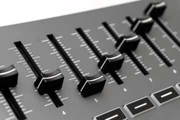 Closeup of a mixing desk. Digital mixing sound console with faders and buttons.