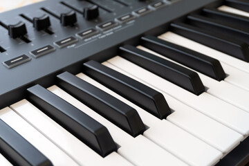 Close up of music instrument synthesizer keyboard with buttons and faders.