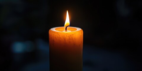 A funeral candle in a dark room, casting a soft glow as mourners pay their respects.
