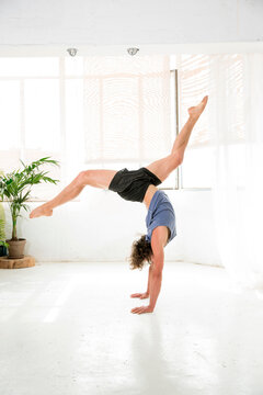 Young man practicing cartwheel at studio