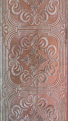 vintage pressed tin ceiling tile with ornate floral medallion pattern and embossed scrollwork design in rose gold metallic finish