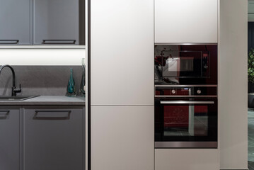 Fototapeta premium Black built-in microwave and oven with a seamless finish