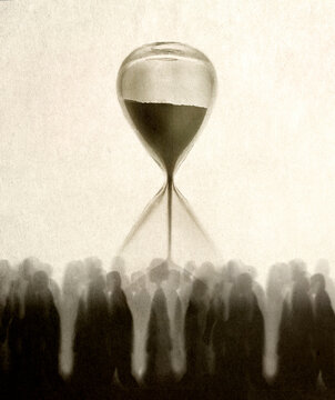 People walking in front of oversized hourglass