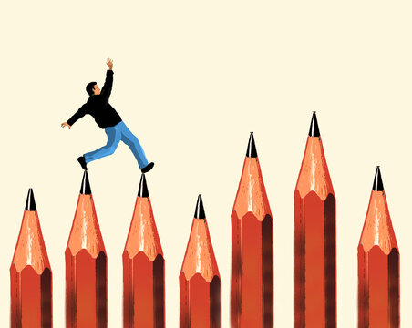 Man balancing on pencils against beige background