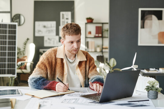 Employee sitting in front of laptop at office