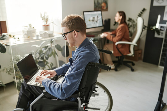 Employee with disability using laptop in office