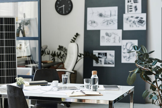 Documents and drinking glass kept on table in modern office