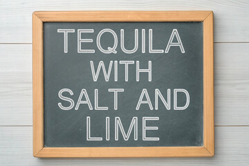 Fototapeta premium Tequila with salt and lime. On the chalkboard.