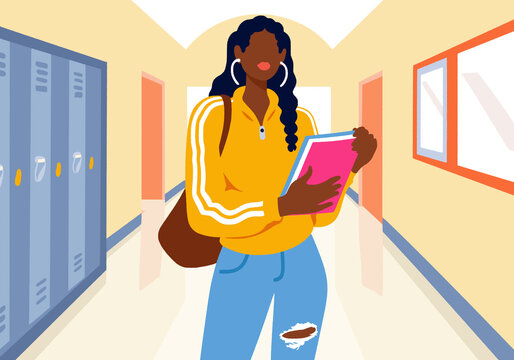 Student holding books and standing in school corridor