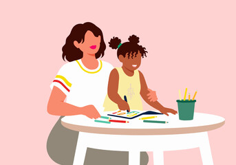 Grandmother and granddaughter drawing together sitting at table