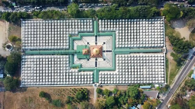 A stunning aerial view of Kuthodaw Pagoda in Mandalay, Myanmar, surrounded by 729 white shrines that house the world's largest book, with a golden stupa at the center of the symmetrical layout