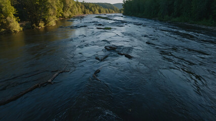 Scenic River Flowing Through Forest with Autumn Trees, Rocks, and Mountain Reflection at Sunset