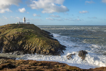 Strumble Head Lighthouse on the Pembrokeshire Coast in Wales during high winds