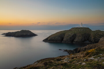 Strumble Head Lighthouse on the Pembrokeshire Coast in Wales at sunset