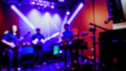 Music band group perform on a concert stage. Guitarist on stage for background, soft and blur concept. Music band performing in a recording studio.